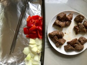 Separate portions of beef, onion and red pepper for Garlic Steak Kabobs. #beefkabobs #steakkabobs