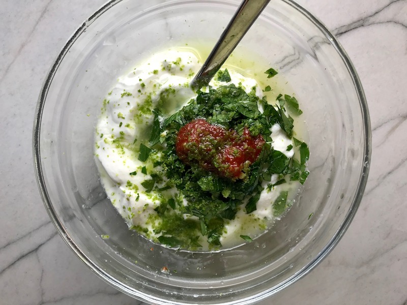 Sour cream, lime, cilantro, and sriracha in bowl for Korean Beef Tacos with flavorful Korean beef, crunchy Sesame Cabbage Slaw and a creamy, cool, Cilantro Lime Sriracha sauce!