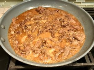 Korean Flank steak cooking in pan for Korean Bulgogi Sauce Beef Tacos with flavorful Korean beef, crunchy Sesame Cabbage Slaw and a creamy, cool, Cilantro Lime Sriracha sauce!