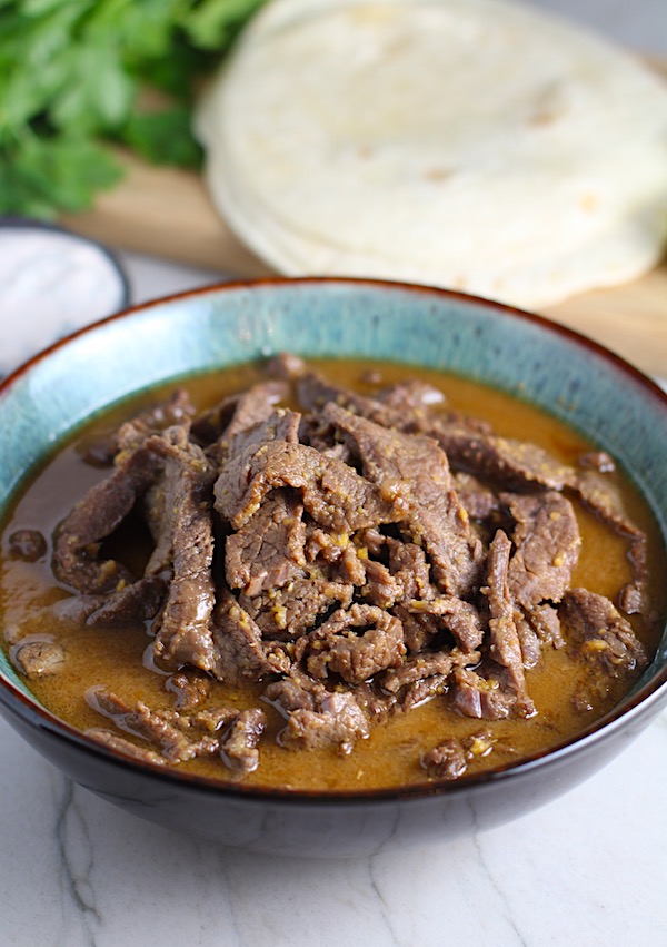 Beef Bulgogi in a bowl for Korean Beef Tacos with flavorful Korean beef, crunchy Sesame Cabbage Slaw and a creamy, cool, Cilantro Lime Sriracha sauce!