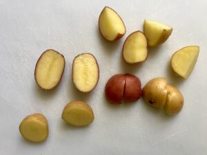 Cut raw red potatoes for Harissa Potato Salad Recipe with Edamame and Harissa. It's creamy, crunchy, meaty, tangy, peppery, salty, and oh, it's UNBELIEVABLE!