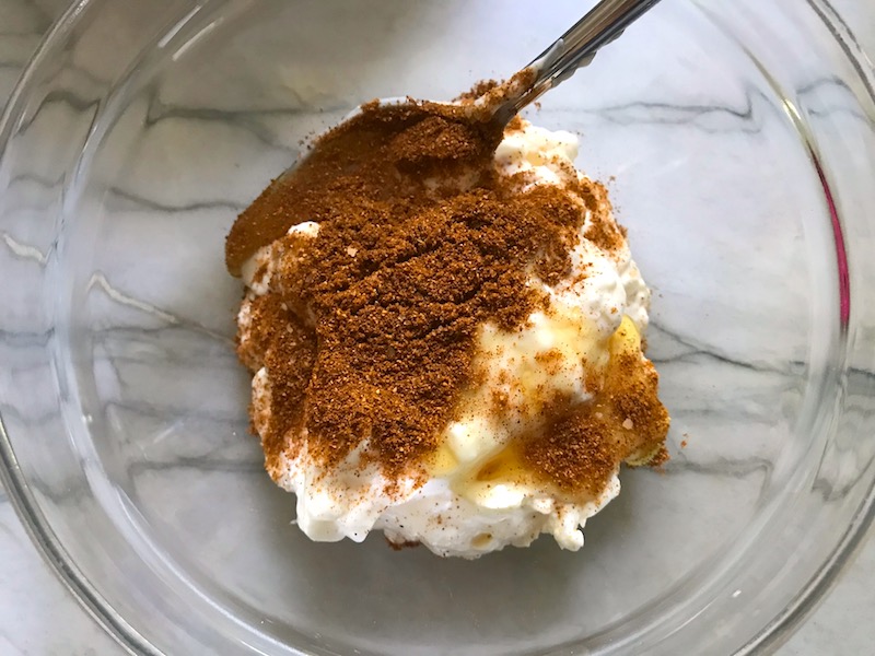 Harissa powder and mayo in a bowl for Harissa Potato Salad Recipe with Edamame and Harissa. It's creamy, crunchy, meaty, tangy, peppery, salty, and oh, it's UNBELIEVABLE!