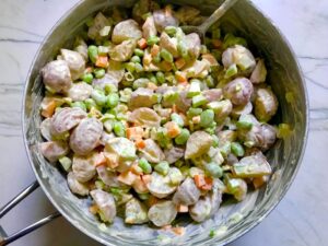 Harissa Potato Salad Recipe with Edamame and Harissa in a pot. It's creamy, crunchy, meaty, tangy, peppery, salty, and oh, it's UNBELIEVABLE!