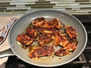 Blackened chicken in pan for Creamy Corn and Blackened Chicken skillet dinner