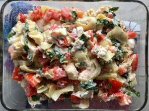 Topping added on top of chicken for Chicken Artichoke Bake with Tomatoes and Goat Cheese. It's a creamy, tangy, sweet, savory, mouth watering easy dinner that you can prep ahead!