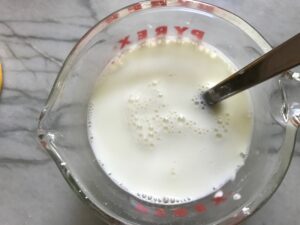 Cornstarch and Milk slurry in measuring cup for Broccoli Cheese Quinoa Bake It's a comfy cozy casserole that's perfect to make ahead for a simple weeknight side or main dish.