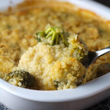 Spoon scooping Broccoli Cheese Quinoa Bake with potato chips on top. It's a comfy cozy casserole that's perfect to make ahead for a simple weeknight side or main dish.
