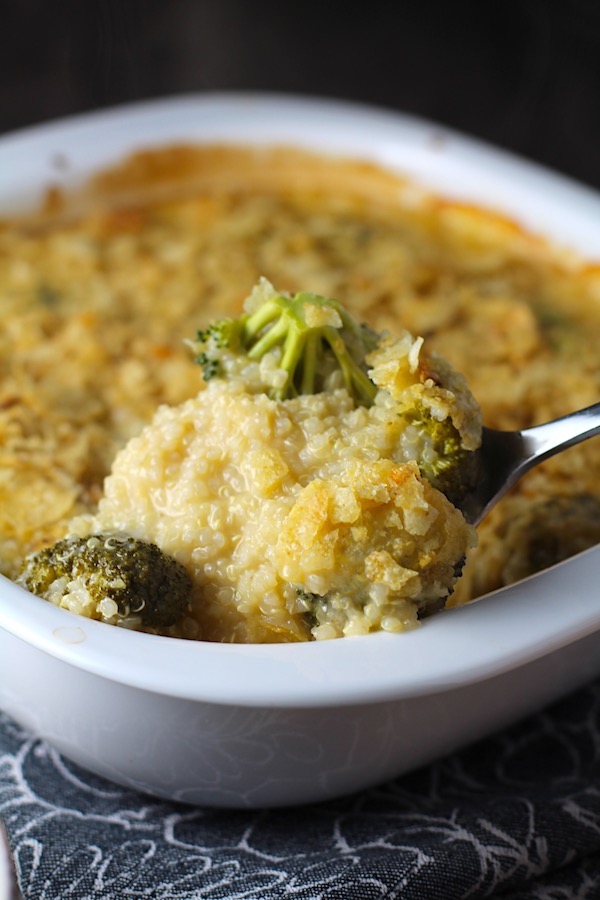 Spoon scooping Broccoli Cheese Quinoa Bake with potato chips on top. It's a comfy cozy casserole that's perfect to make ahead for a simple weeknight side or main dish.