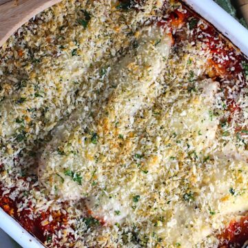 Chicken Parmesan Pasta Bake in casserole pan. It cooks entirely in one casserole dish, including the pasta! Shell pasta in flavorful, tangy tomato sauce is topped with zucchini, chicken, mozzarella, parm, and crunchy breadcrumb topping.