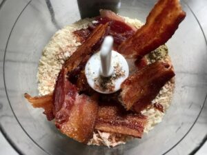 Bacon and breadcrumbs in food processor for Oven Fried Chicken Breast. The chicken is coated with Bacon Crumbs and Honey and it's healthier because it's baked, not fried, but still gives you all of the crispy, crunchy goodness! It also gives you sweet and salty crunch with the addition of honey and bacon!