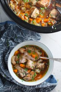 Paprika Pork Stew Recipe in a bowl with carrots, onion, parsley. It's an easy family dinner.