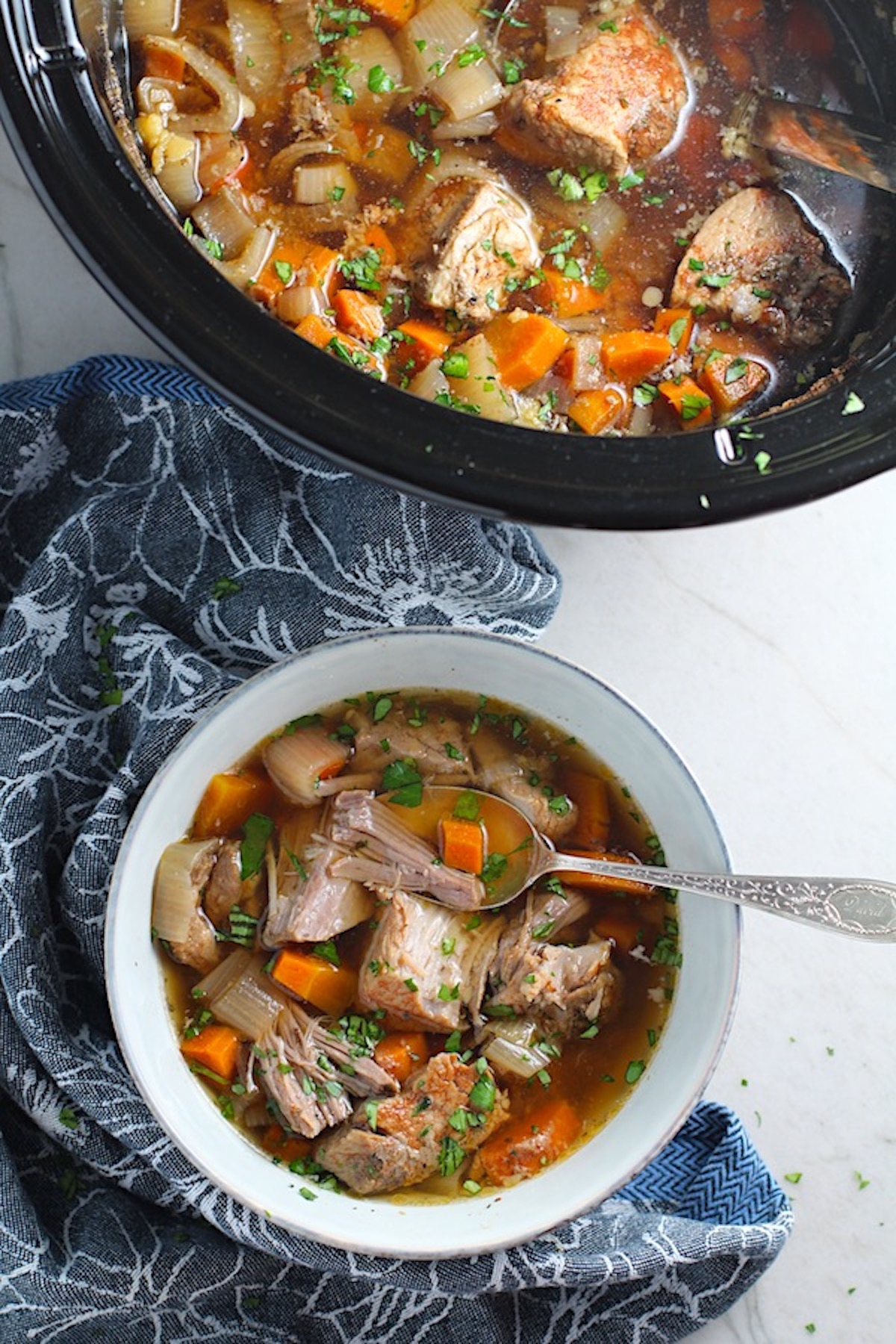 Paprika Pork Stew Recipe in a bowl with carrots, onion, parsley. It's an easy family dinner.