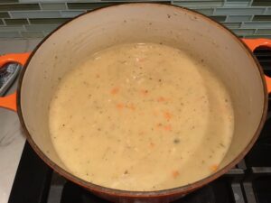 Thickened soup in pot for Creamy Chicken Sausage and Tortellini Soup. It's silky and creamy with onions, garlic, Chicken sausage, and zucchini bring so much flavor and texture. The tortellini give that delicious salty, creamy, hearty bite!