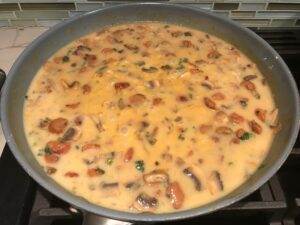 Thickened chorizo and mushroom sauce for Creamy Green Beans and Mushrooms with Chorizo in a serving bowl are a creamy and savory side dish.