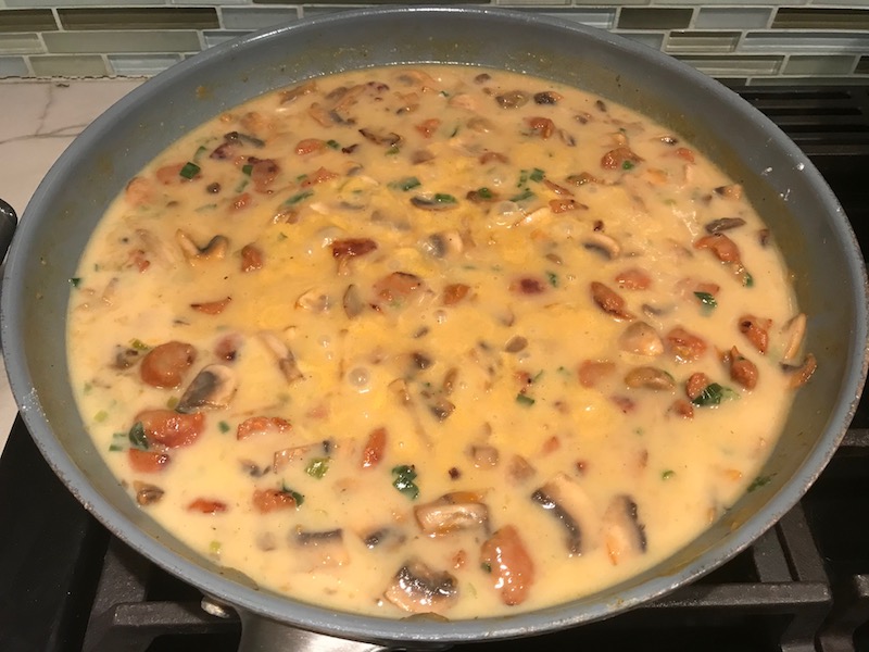 Thickened chorizo and mushroom sauce for Creamy Green Beans and Mushrooms with Chorizo in a serving bowl are a creamy and savory side dish.