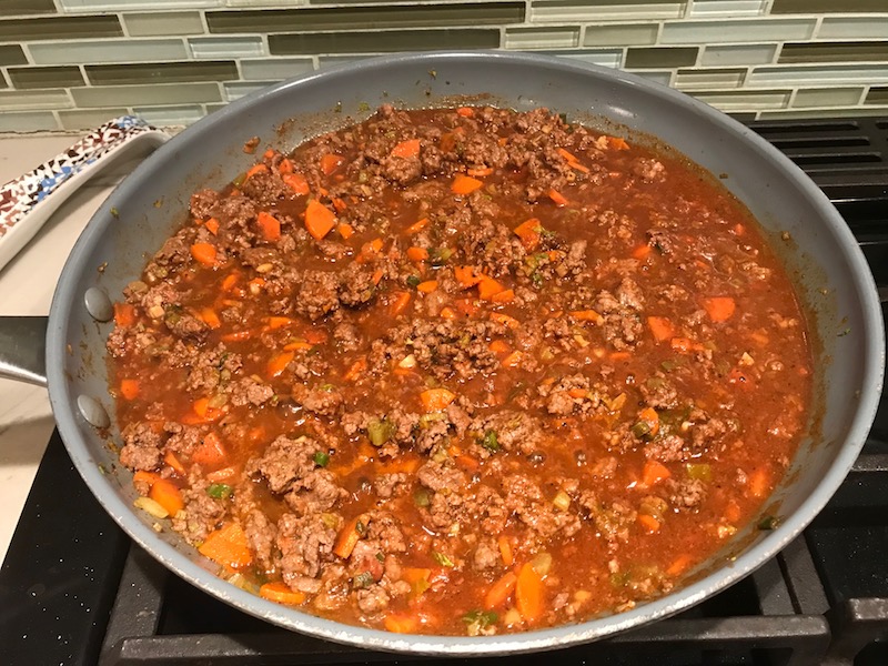 Beef mixture in skillet for Empanada Beef Pie Recipe. It has a perfect flaky, buttery pastry on the outside with a savory, smokey, salty ground beef filling. The best part is that everything cooks in one skillet!