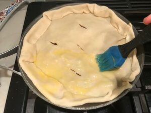 Pie crust on skillet for Empanada Beef Pie Recipe. It has a perfect flaky, buttery pastry on the outside with a savory, smokey, salty ground beef filling. The best part is that everything cooks in one skillet!