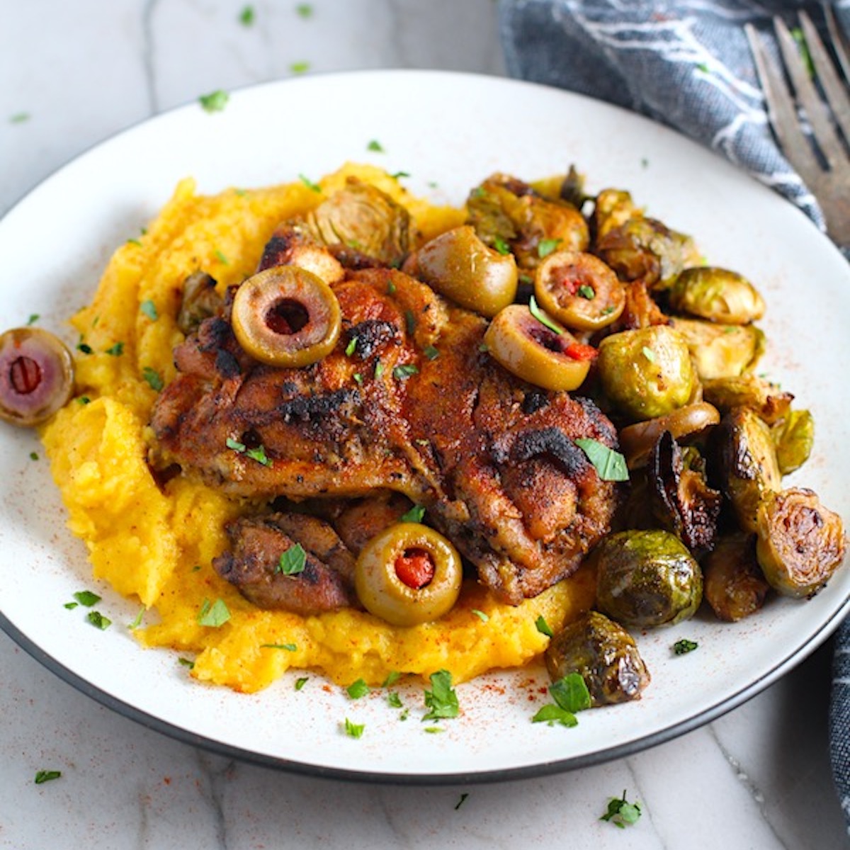 n a plate with Butternut Squash Mash, Olives, and Brussels Sprouts! It's warm, hearty, and smoky.