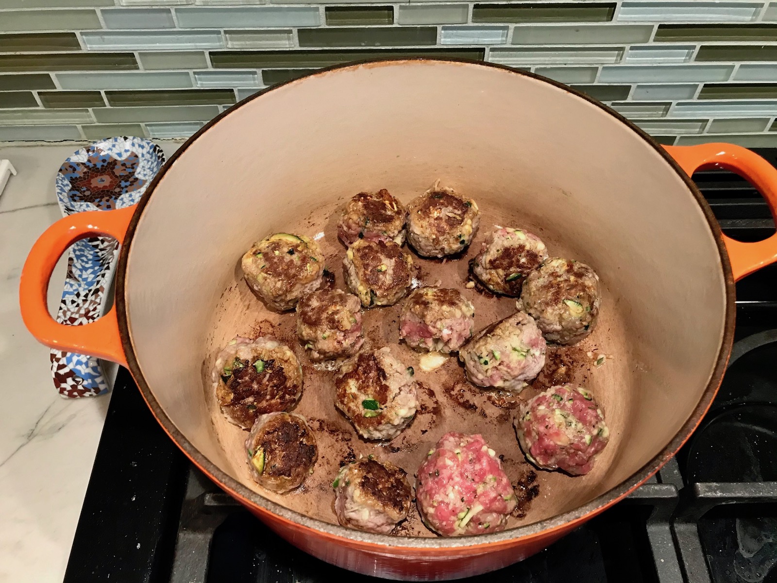 Meatballs cooking in pot for Healthy Meatballs with Zucchini & Lean Beef. They're loaded with flavor from the garlic, minced onion, salt, and pepper. The zucchini brings moisture, texture, and bulks up the meatballs with healthiness.