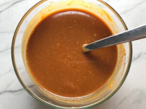 Thai peanut sauce mixed in a bowl for Thai Peanut Sauce Noodles with seared tofu and veggies.