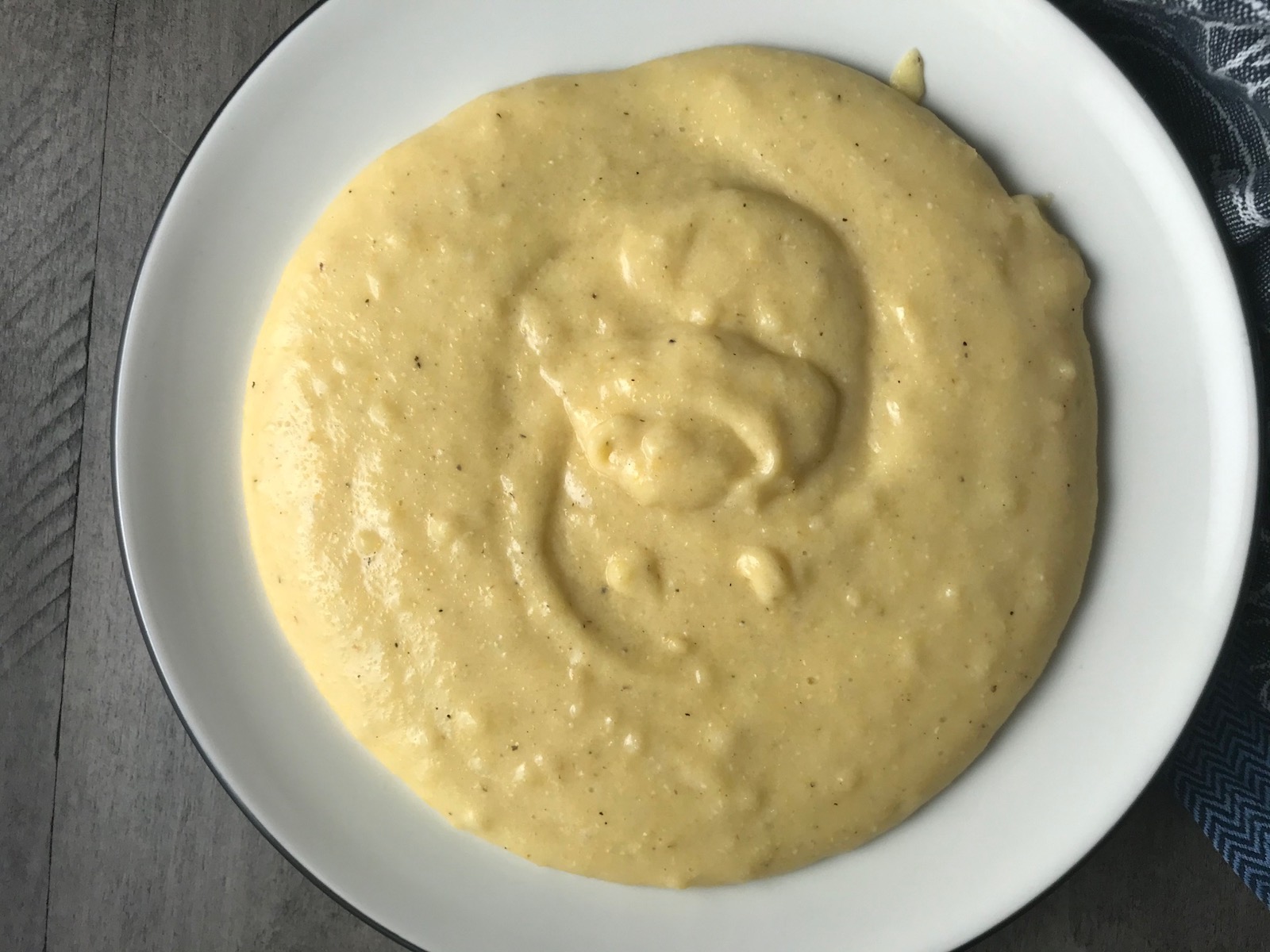 Creamy cheesy grits on a plate for Shrimp and Grits recipe.