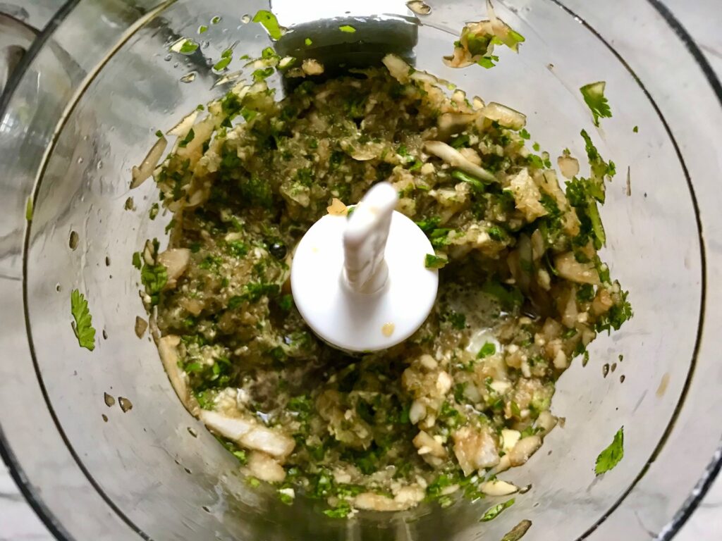 Cilantro, onion, garlic, and Soy sauce blended in food processor for Honey Garlic Beef and Potatoes. It's a delicious easy dinner made in the slow cooker with tender beef cubes are cooked in the slow cooker with lots of delicious garlic, onions, and potatoes. Then honey and molasses are added for that touch of sweet.