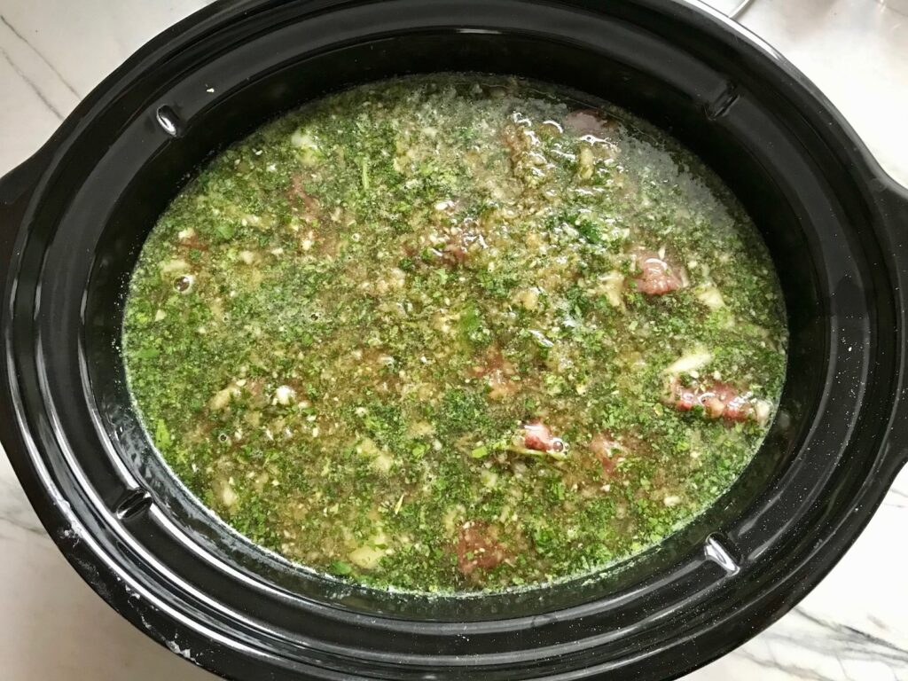 All ingredients in slow cooker for Honey Garlic Beef and Potatoes. It's a delicious easy dinner made in the slow cooker with tender beef cubes are cooked in the slow cooker with lots of delicious garlic, onions, and potatoes. Then honey and molasses are added for that touch of sweet.