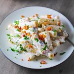 Ricotta Sauce Pasta with Bacon and Mushrooms on a plate with fork and pan in background. It's creamy, rich, decadent, comforting, and downright delicious! Finally, shelled edamame for a bit of color and texture!