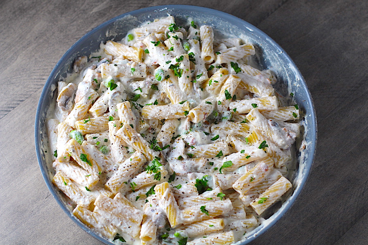 Ricotta Sauce Pasta with Bacon, Mushroom Sauce in a pan with parsley on top. It's creamy, rich, decadent, comforting, and downright delicious! Finally, shelled edamame for a bit of color and texture!