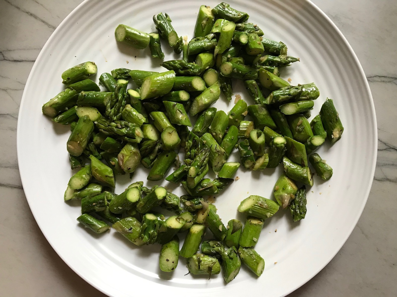 Cut cooked asparagus on a plate for Asparagus and Tomato Quinoa Risotto