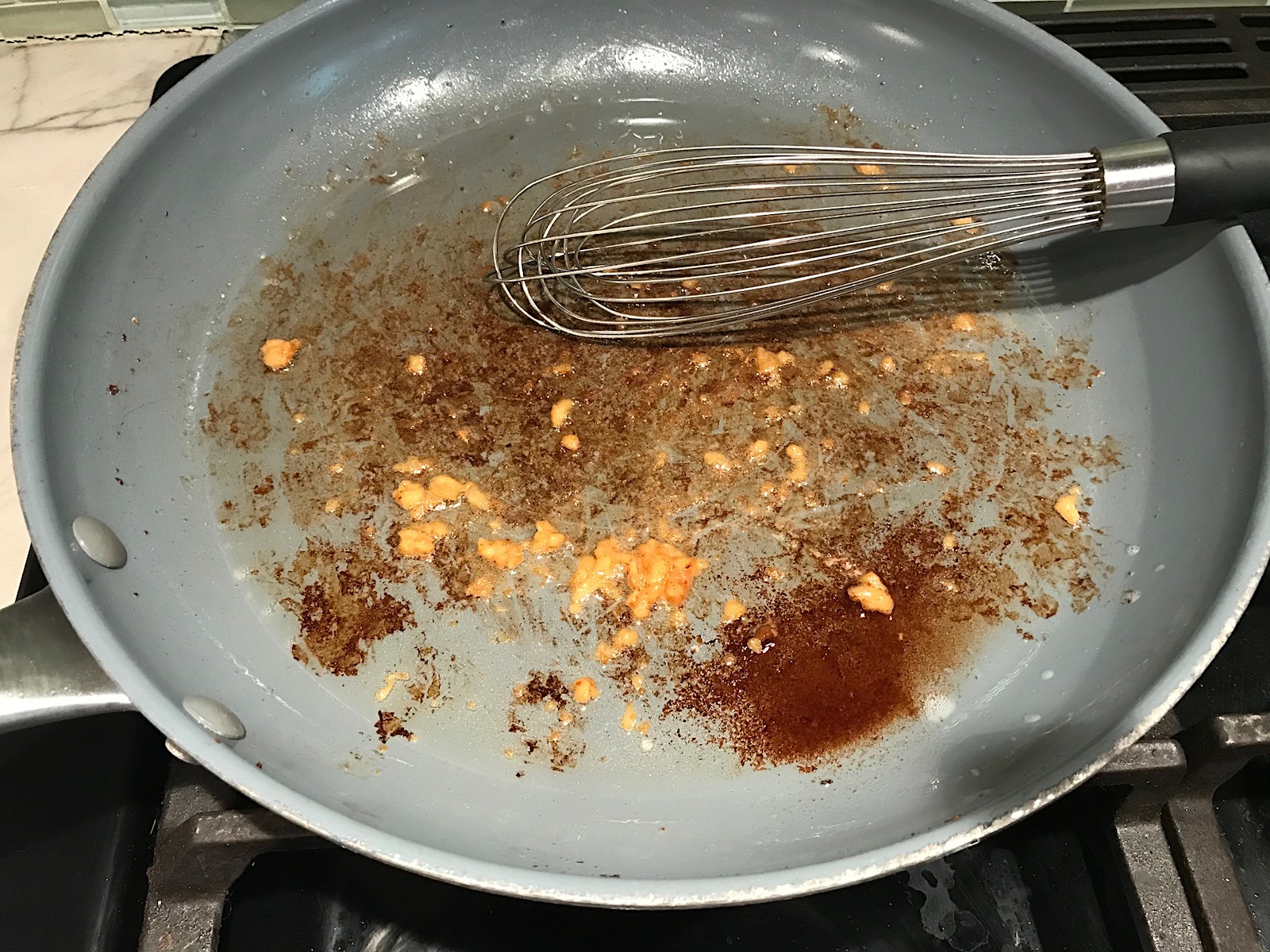 Garlic added to bacon fat in large frying pan for Velvety Barley Recipe with Bacon and Gruyere Cheese. It's creamy, rich, nutty, smokey, hearty, and utterly delicious.
