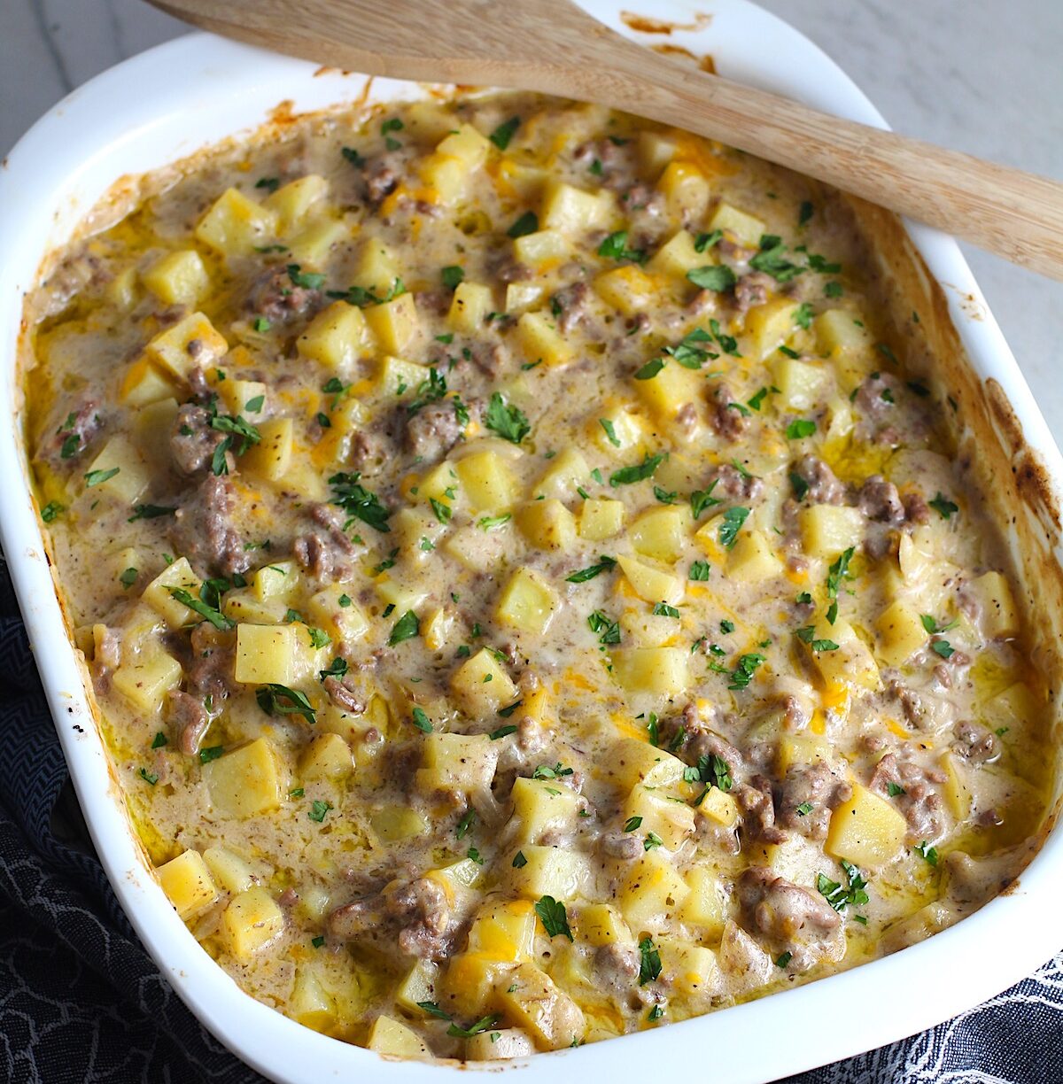 Cheesy Hamburger Potato Casserole in a casserole dish. It's an easy, yummy, and cozy weeknight family dinner.