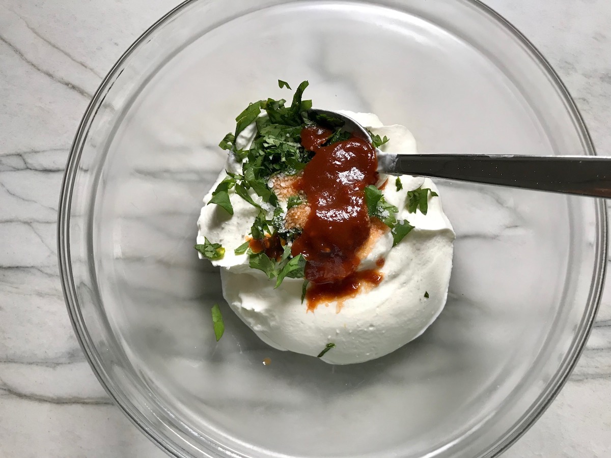 Sour Cream, cilantro, and chipotle in adobo in a bowl for for Grilled Shrimp Tacos