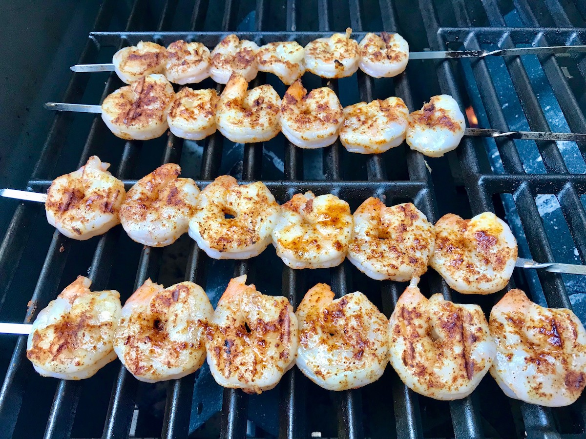 Shrimp skewers grilling on outdoor grill for Grilled Shrimp Tacos