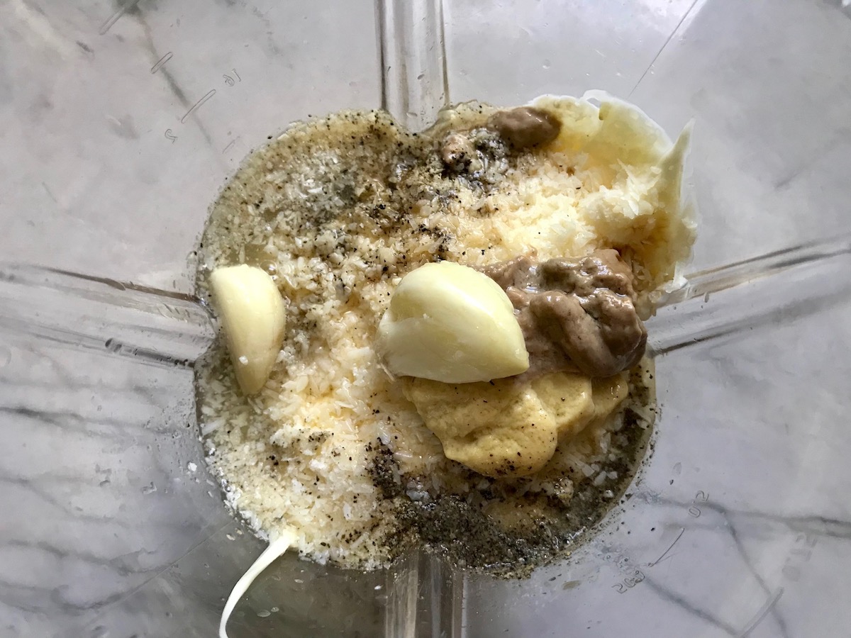 Blender with Caesar dressing ingredients for Kale Caesar Salad with Baked Crispy Lemon Chicken strips