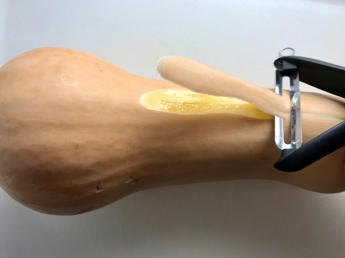 Y-Peeler peeling butternut squash on counter for Butternut Squash and Chicken with Shallots.