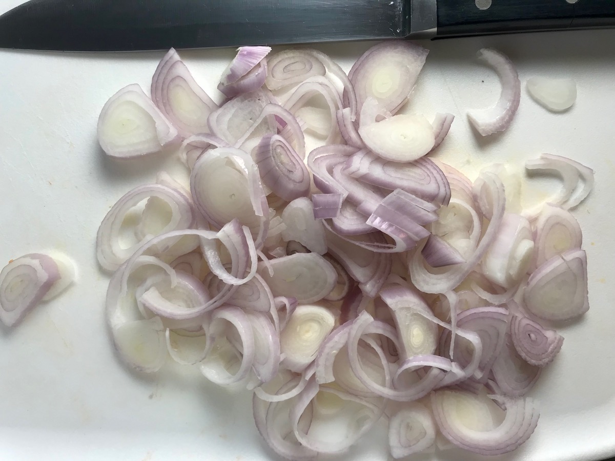 Sliced raw shallots for Butternut Squash and Chicken with Shallots.