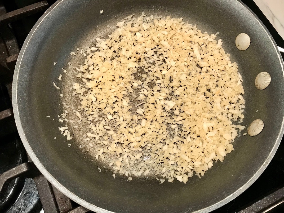 Breadcrumbs toasting in a pan for Southwestern Pasta with Ground Beef and Corn and breadcrumbs. The sauce is thick and hearty with ground beef, sweet corn kernels, chunky tomatoes, chipotle peppers in adobo, green chiles, parmesan cheese, and lots of smokey and spicy seasonings.