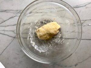 Dumpling dough in clear bowl on counter for Chicken Goulash with quick homemade dumplings.