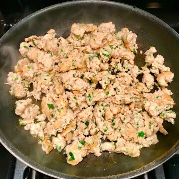 Ground Italian Chicken Sausage cooked in a frying pan..