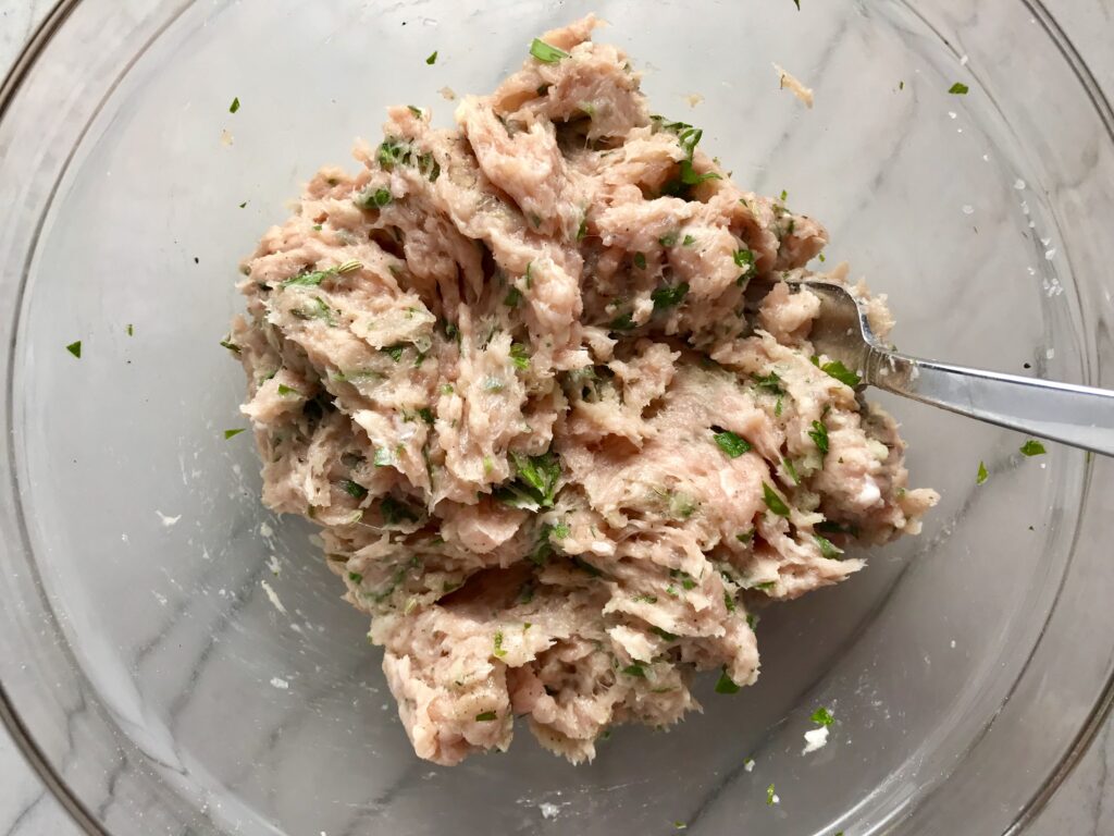Ingredients in bowl for Ground Italian Chicken Sausage.