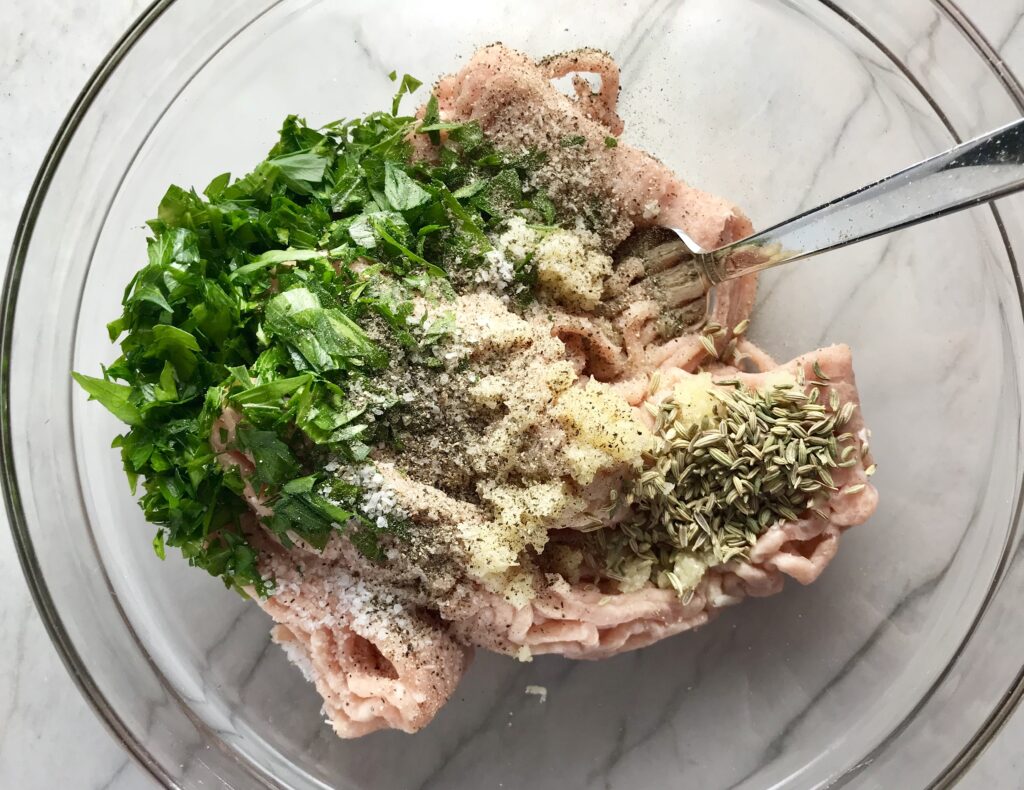 Ingredients in bowl for Ground Italian Chicken Sausage.