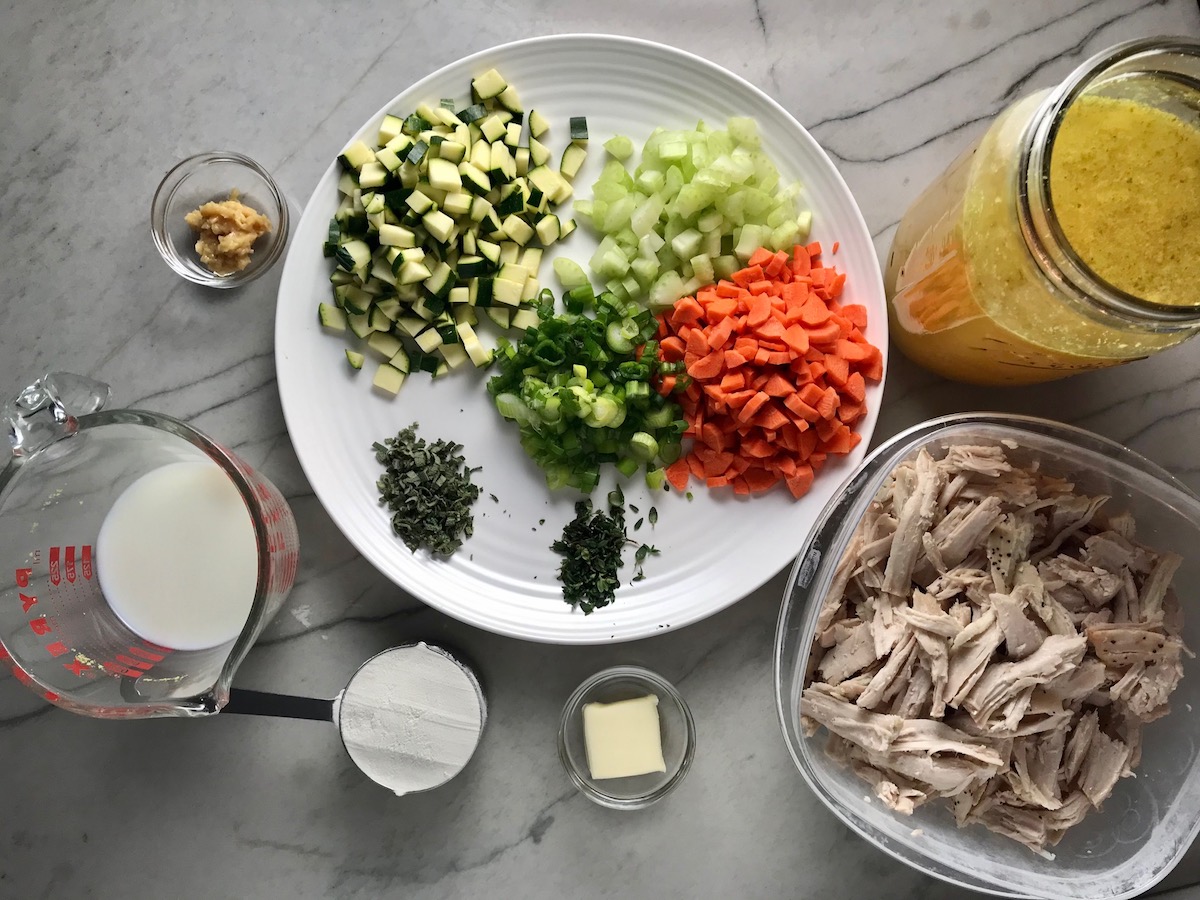 All ingredients on counter for Puff Pastry Turkey Pot Pie. It's an easy dinner recipe to use leftover turkey from the holidays and ingredients you can have on hand! The vegetables and sauce come together so easily and store-bought puff pastry is a time saver.
