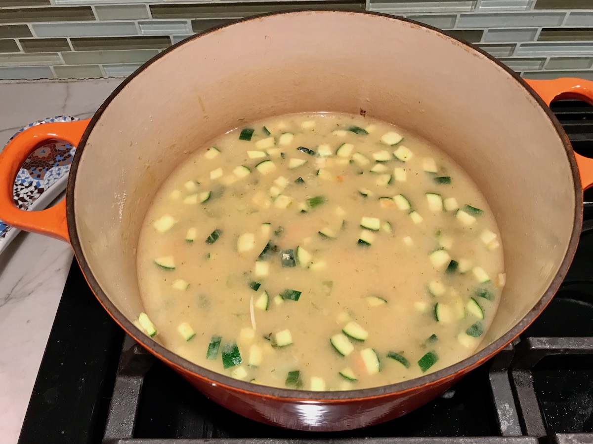 Pot Pie filling cooking in pot for cooking in pot for Puff Pastry Turkey Pot Pie. It's an easy dinner recipe to use leftover turkey from the holidays and ingredients you can have on hand! The vegetables and sauce come together so easily and store-bought puff pastry is a time saver.