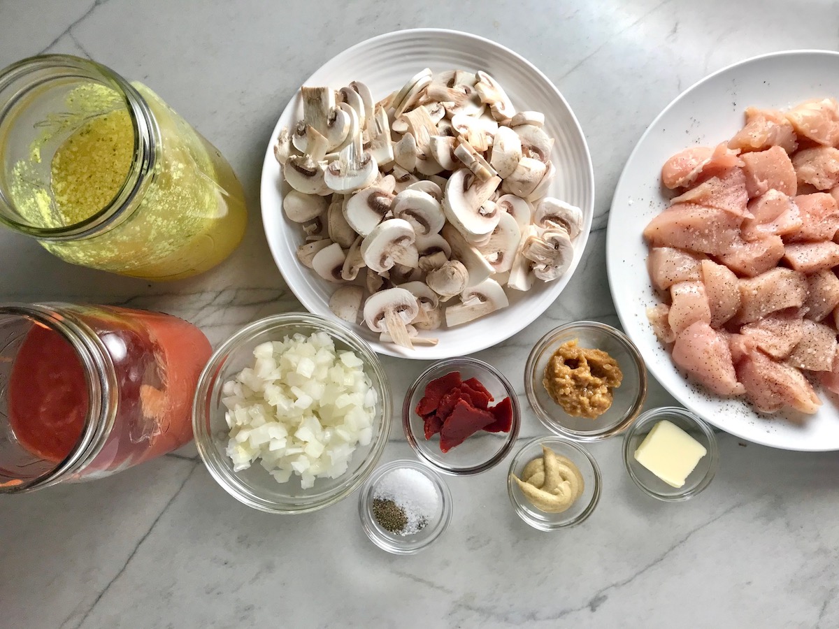 All ingredients chopped and measured in bowls on counter for Chicken Stroganoff Brazilian Style. It's an easy 30 minute dinner with a tomato based sauce, cream, and mushrooms all over rice.