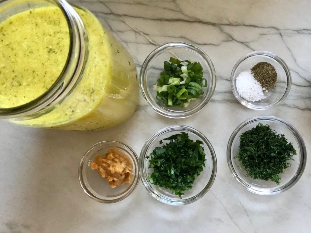Ingredients in bowls on counter for Ranch Chicken Crock Pot Pasta recipe. It uses fresh dill, parsley, and scallions is creamy, tangy, and utterly delicious! It's also so easy to make, so it's a great weeknight dinner.