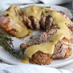 Thick gravy over sliced roast pork tenderloin. This Roast Pork Gravy Recipe is thick, creamy, and full of flavor.