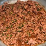 Cooked ground beef and taco seasoning for Taco Meat recipe.