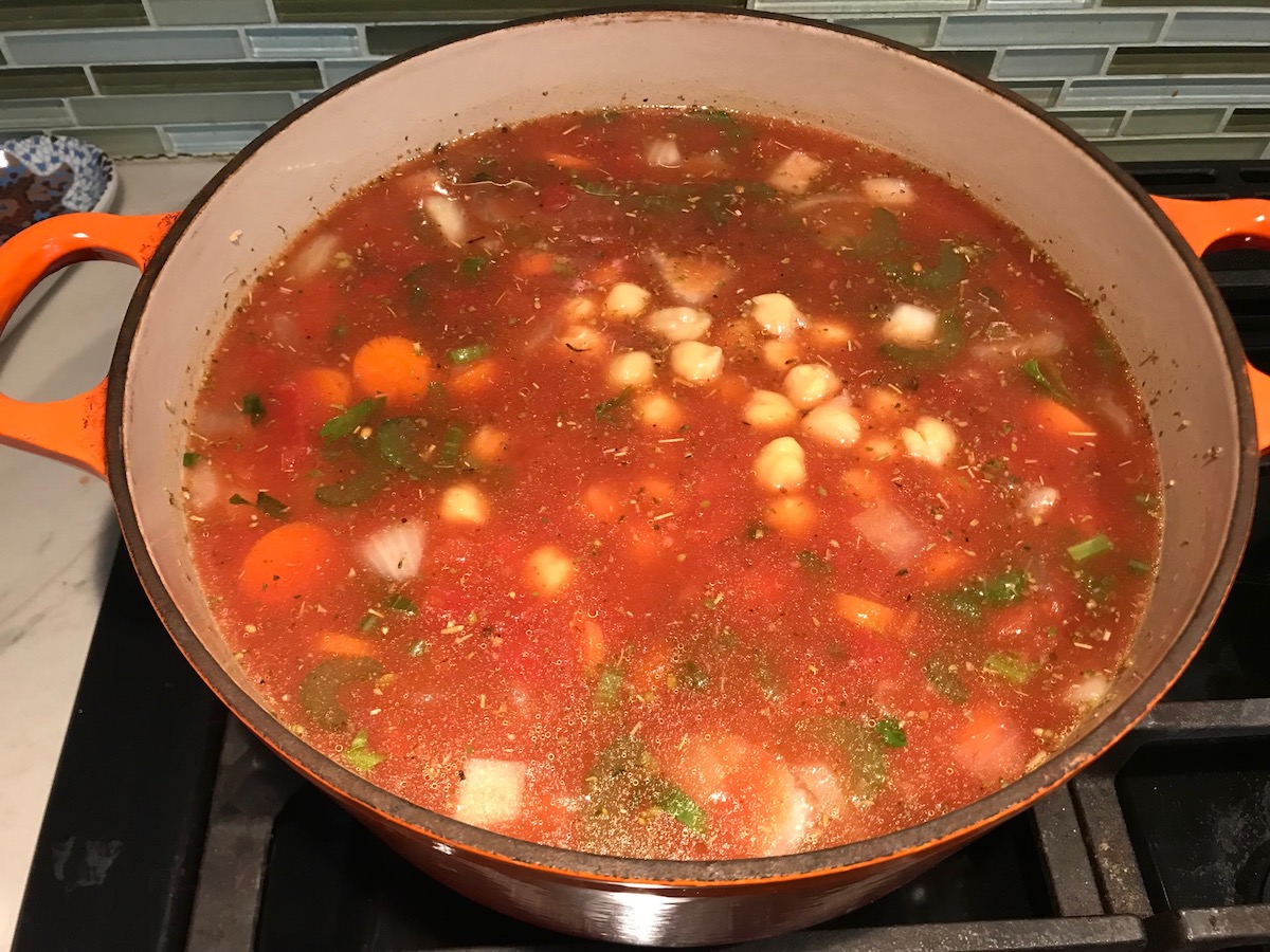 Vegetable Garbanzo Soup recipe in a pot on the stove. It's slightly creamy and filled with flavor and texture! It's super easy to make ahead and enjoy during the week.
