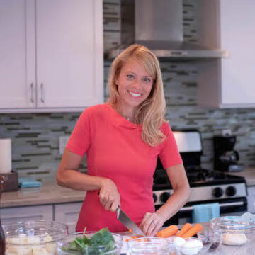 Carrie Tyler in kitchen meal prepping at the counter for Theme Night Dinner Ideas.